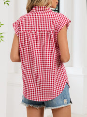 Red gingham cotton shirt with cap sleeves and button-down front, styled casually.