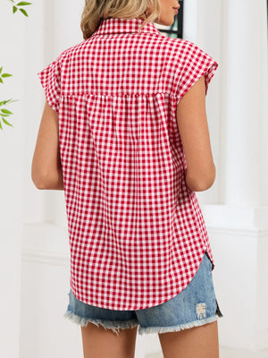 Red gingham cotton shirt with cap sleeves and button-down front, styled casually.