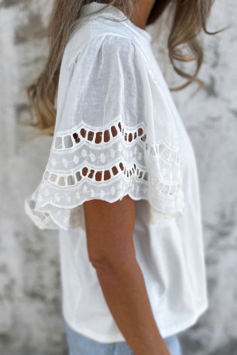 White cotton tee with eyelet lace inset flutter sleeves and scalloped hem.