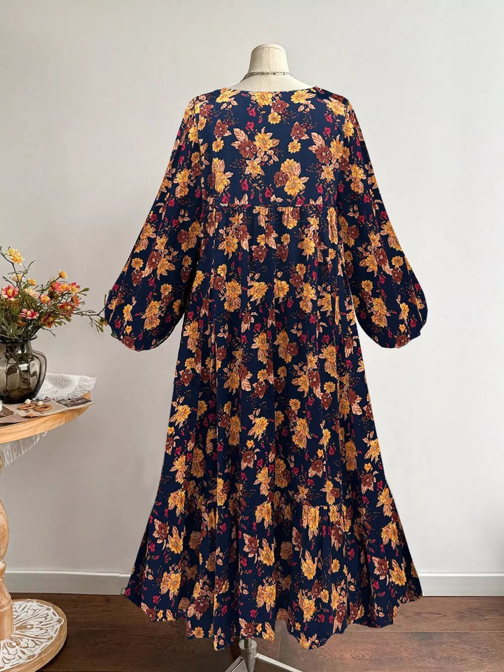 Navy floral print maxi dress with balloon sleeves and tiered skirt.