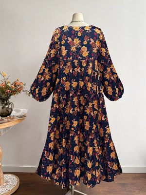 Navy floral print maxi dress with balloon sleeves and tiered skirt.