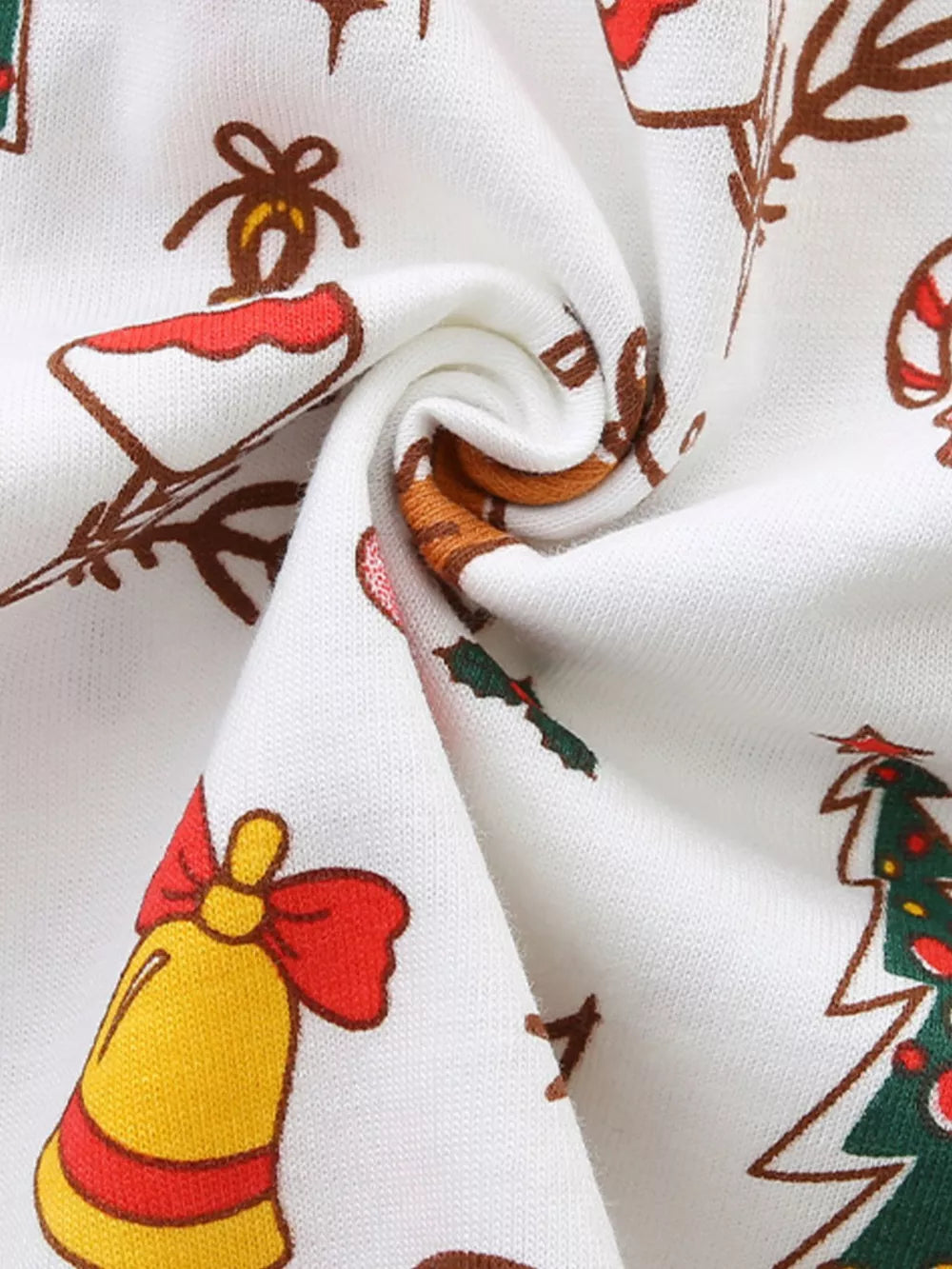 White cotton toddler dress with festive Christmas print of bells, candy canes, and trees.