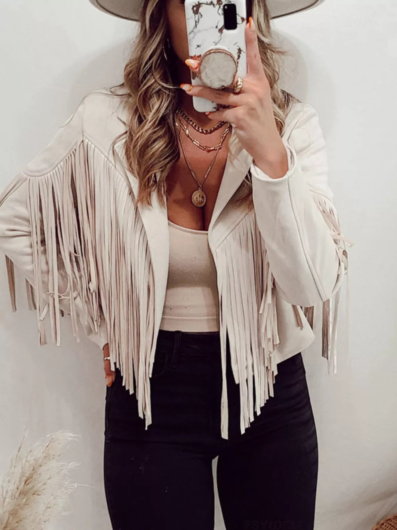 Beige fringe open front cropped jacket with long sleeves and a boho style.