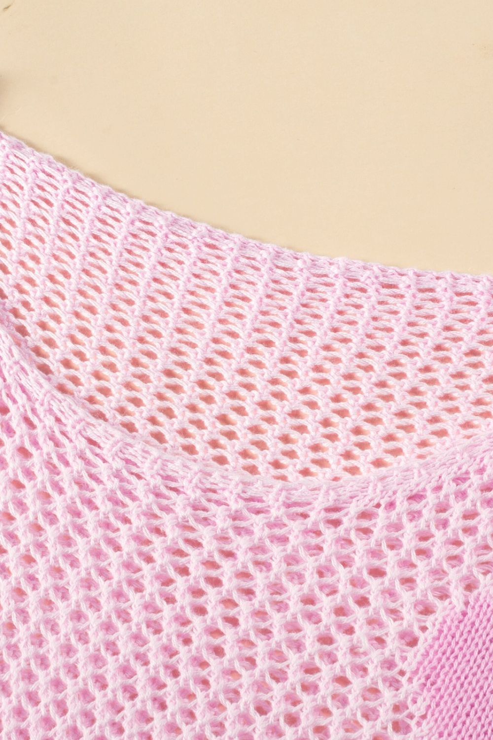 Blush pink openwork knit sweater with a crew neck and intricate floral intarsia detail.