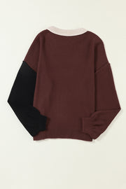 Chic Contrast Cozy Sweater in maroon with black balloon sleeves and a light pink collar.
