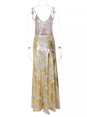 Maxi gown with abstract pattern, V-neck, spaghetti straps, and backless detail.