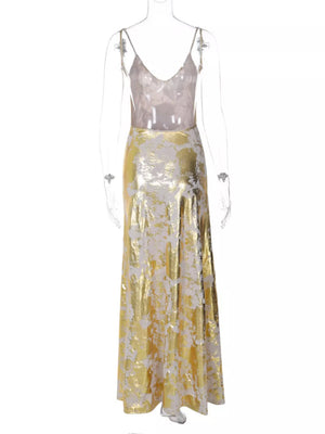 Maxi gown with abstract pattern, V-neck, spaghetti straps, and backless detail.