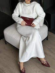 White textured knit co-ord set with relaxed silhouette, featuring a crewneck sweater and wide-leg pants.