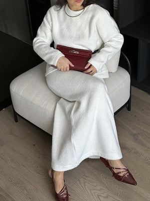 White textured knit co-ord set with relaxed silhouette, featuring a crewneck sweater and wide-leg pants.