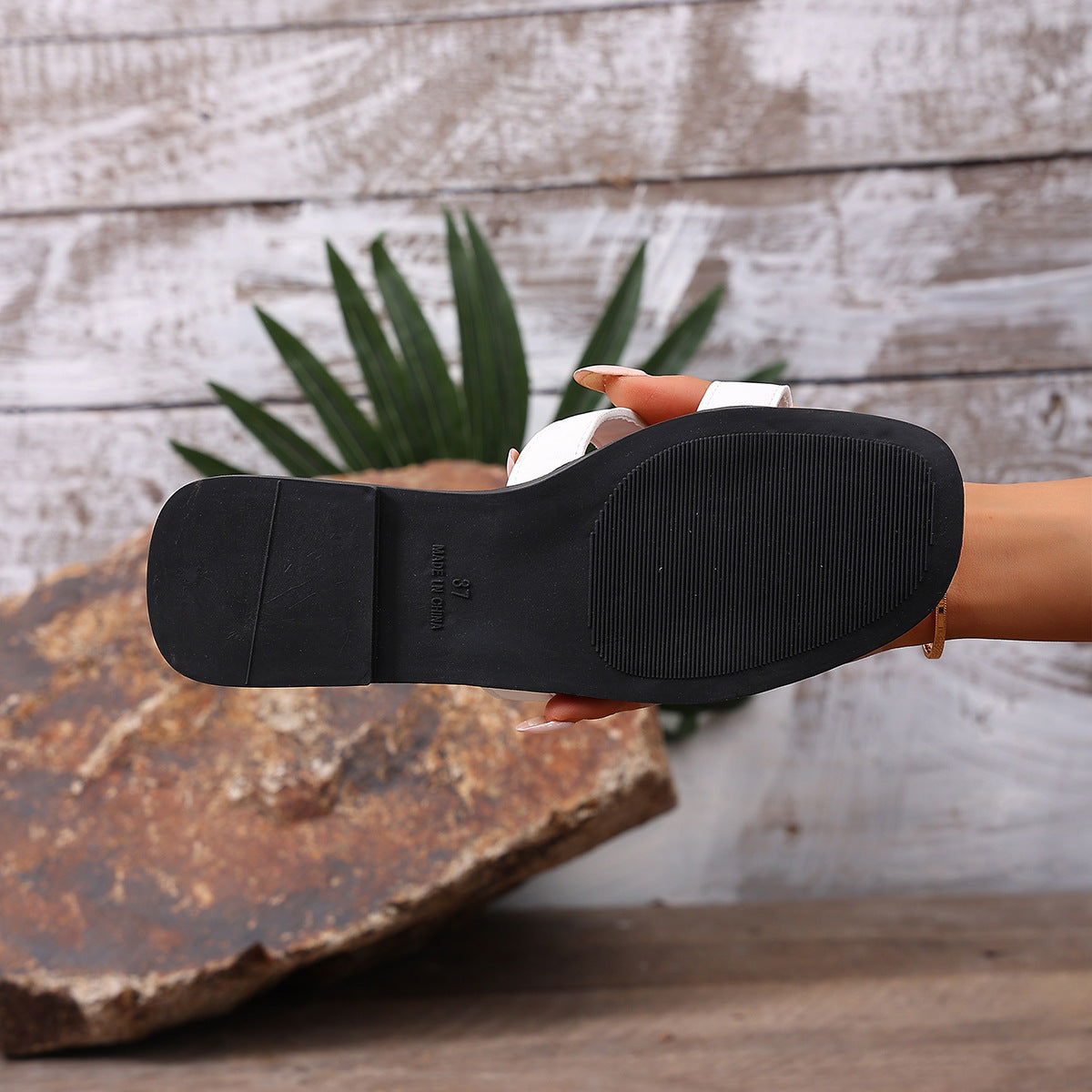 Chic H-strap open-toe sandals in white with a black sole and contrast stitching detail.
