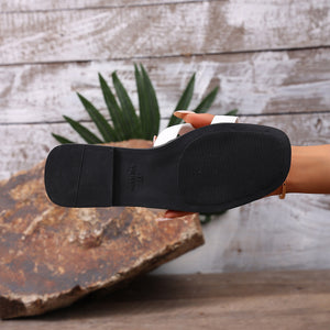 Chic H-strap open-toe sandals in white with a black sole and contrast stitching detail.