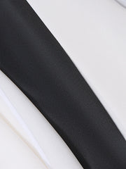 Black and white fabric detail of a dress with a bowknot accent