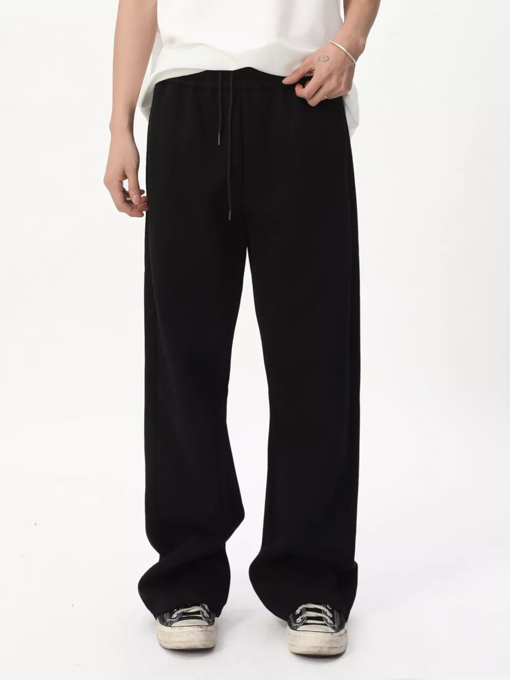 Black relaxed fit sweatpants with adjustable drawstring waist and wide leg