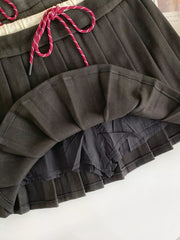 Dark gray pleated skirt with drawstring and built-in shorts.