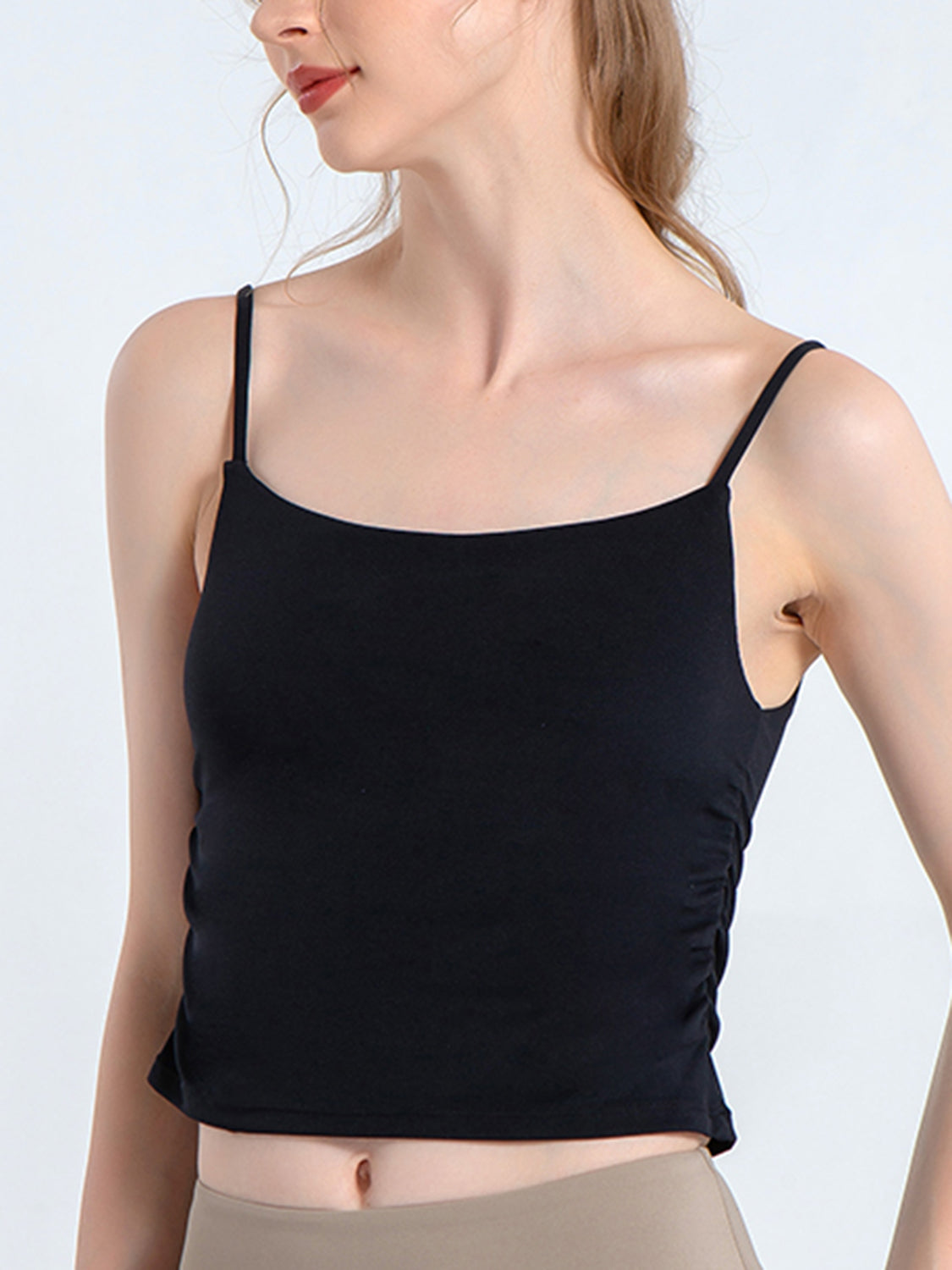 Black tank crop top with side ruching detail and spaghetti straps.