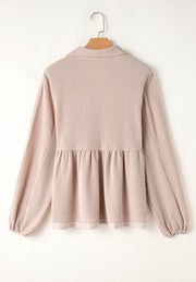 Beige textured blouse with gathered yoke, collar, and balloon sleeves.
