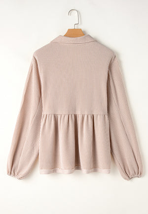 Beige textured blouse with gathered yoke, collar, and balloon sleeves.