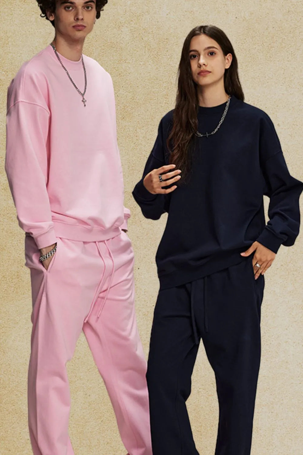 Oversized crewneck sweatshirt in blush pink and navy blue with subtle shoulders.