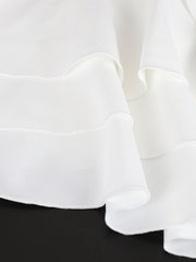 White mini dress with tiered ruffles and scalloped edges.