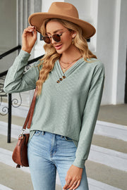 Textured Henley V-Neck Top in Light Green with button detail and long sleeves.