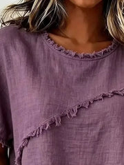 Purple crew neck shirt with frayed asymmetrical hem and neckline detail.