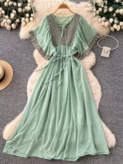 Mint green embroidered V-neck maxi dress with tie waist and flutter sleeves.