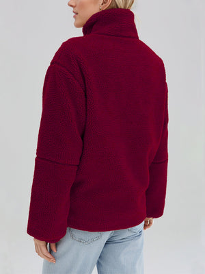 Burgundy sherpa stand-collar jacket with a textured fleece fabric and relaxed fit.