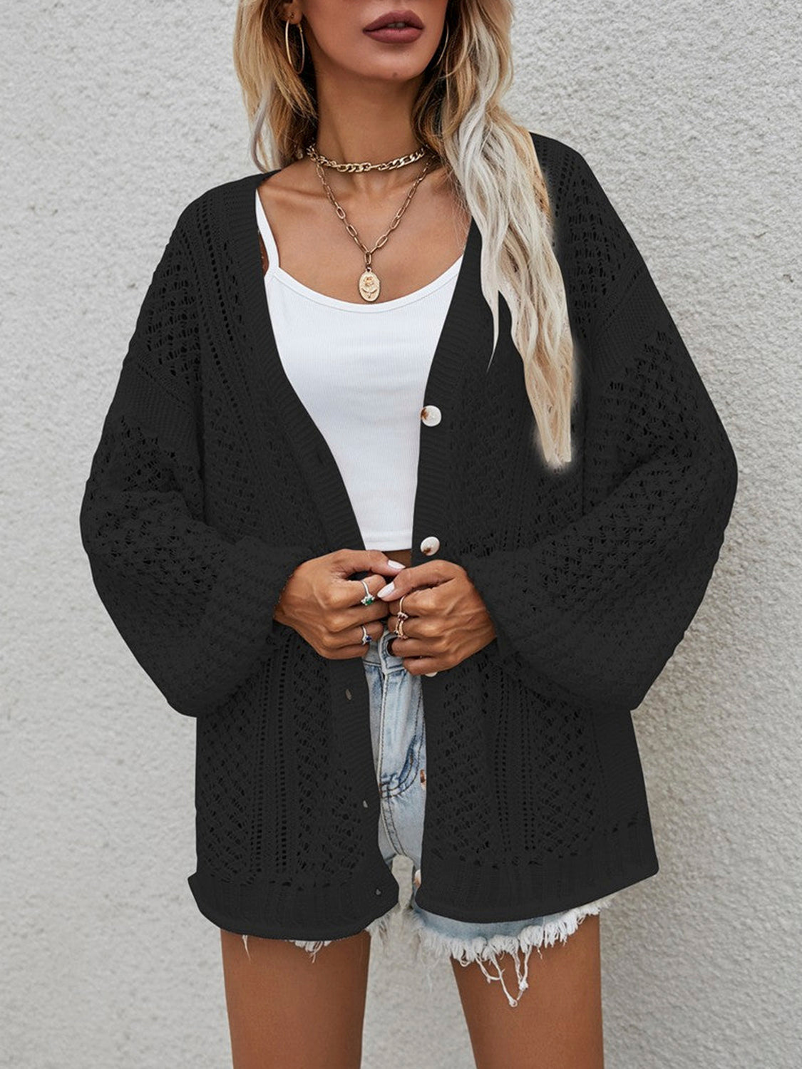 Black open-knit button-down cardigan with balloon sleeves.