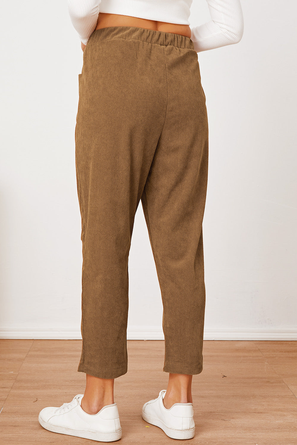 Camel corduroy barrel-leg utility pants with elastic waist and pockets.