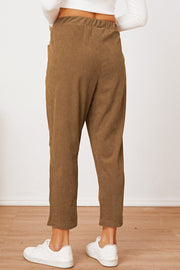 Camel corduroy barrel-leg utility pants with elastic waist and pockets.
