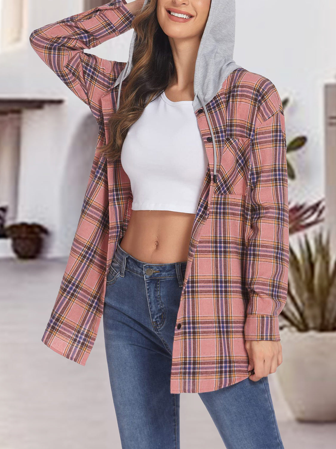Plaid shirt jacket with contrast grey hood and button front, styled open over a white crop top and jeans.