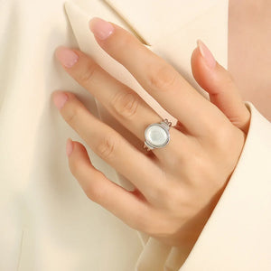 Silver oval signet ring with mother-of-pearl inlay detail on hand