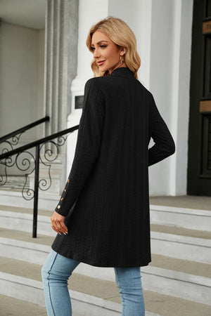 Black textured knit open-front duster cardigan with gold button detail on sleeve cuff.