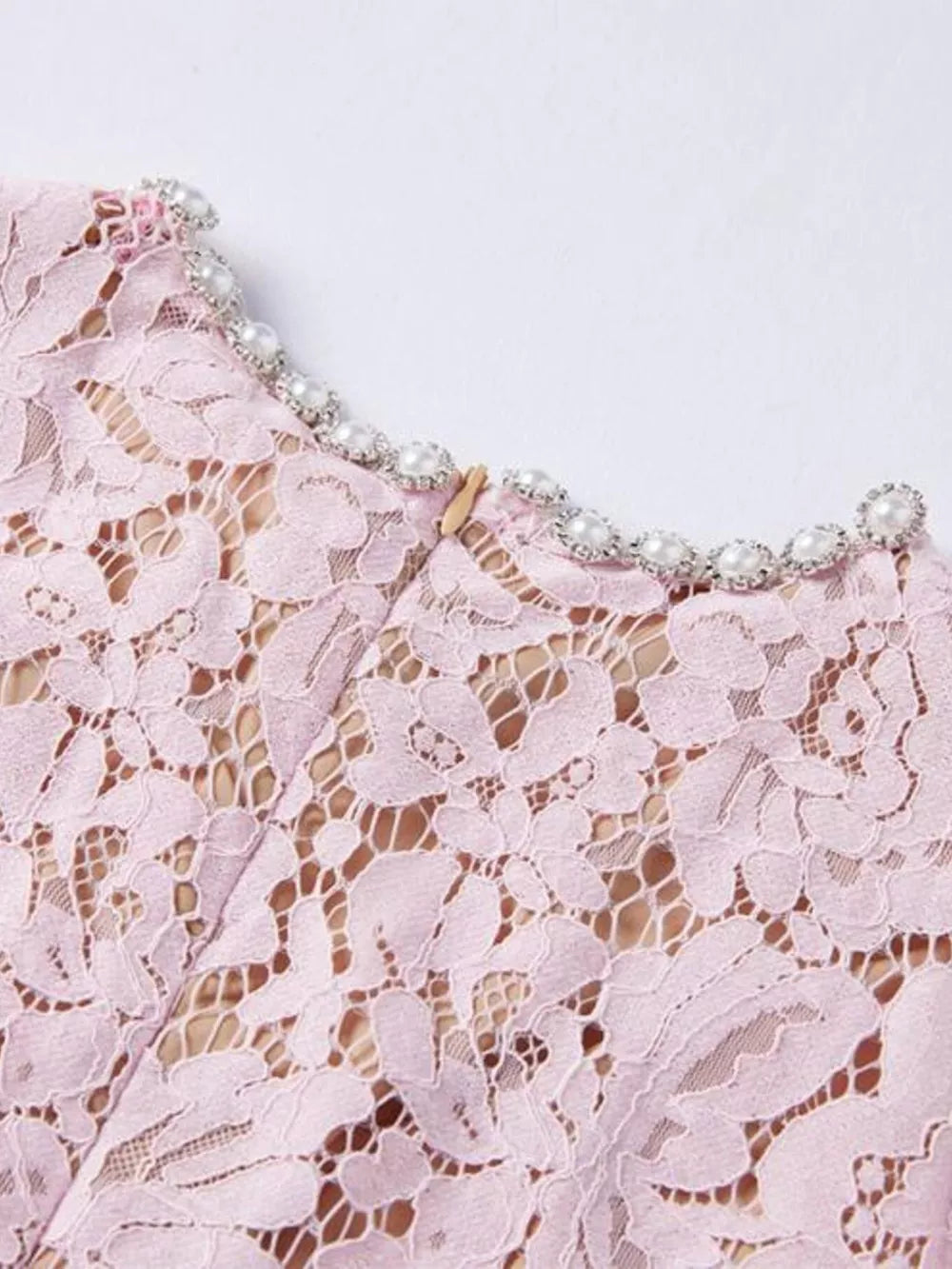 Powder floral lace mermaid dress with pearl and rhinestone neckline detail.
