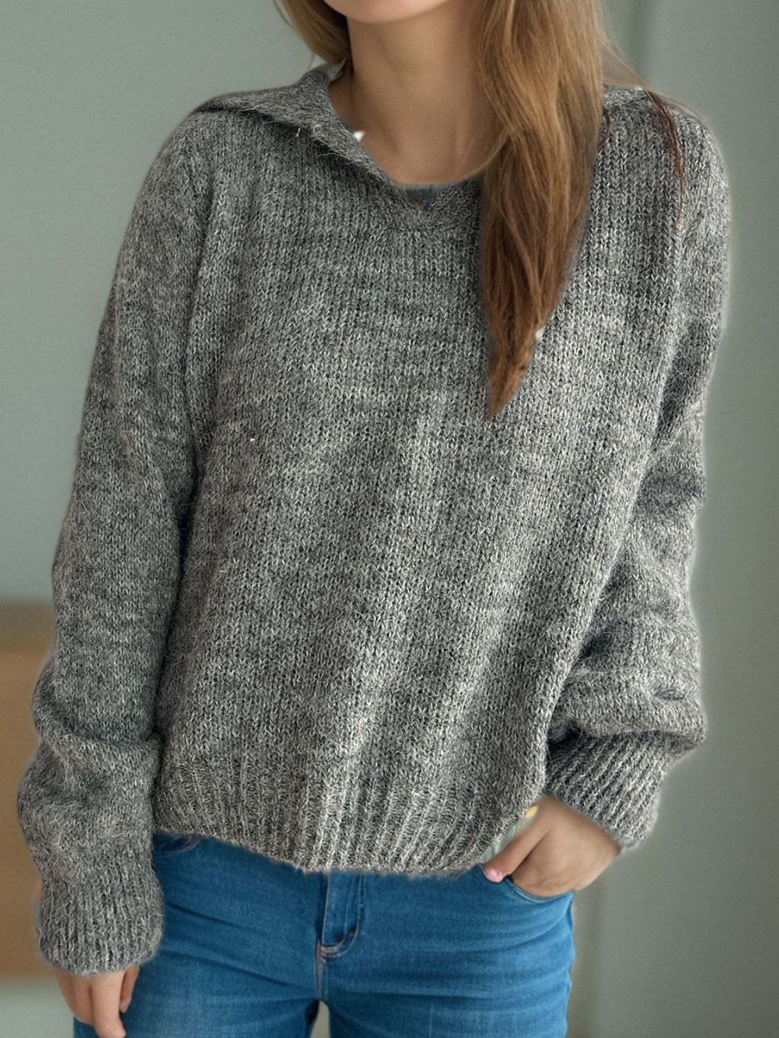 Textured knit polo sweater in dark gray with ribbed cuffs and hem.
