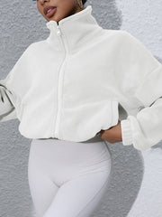 White fleece cropped funnel neck jacket with zip front and pockets.
