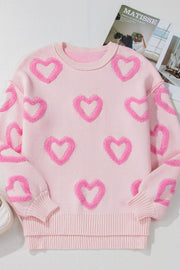 Pink knit sweater with allover fuzzy heart appliqué and balloon sleeves.