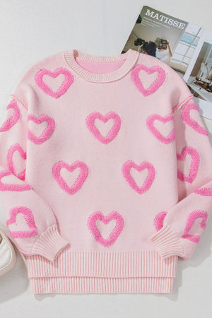 Pink knit sweater with allover fuzzy heart appliqué and balloon sleeves.