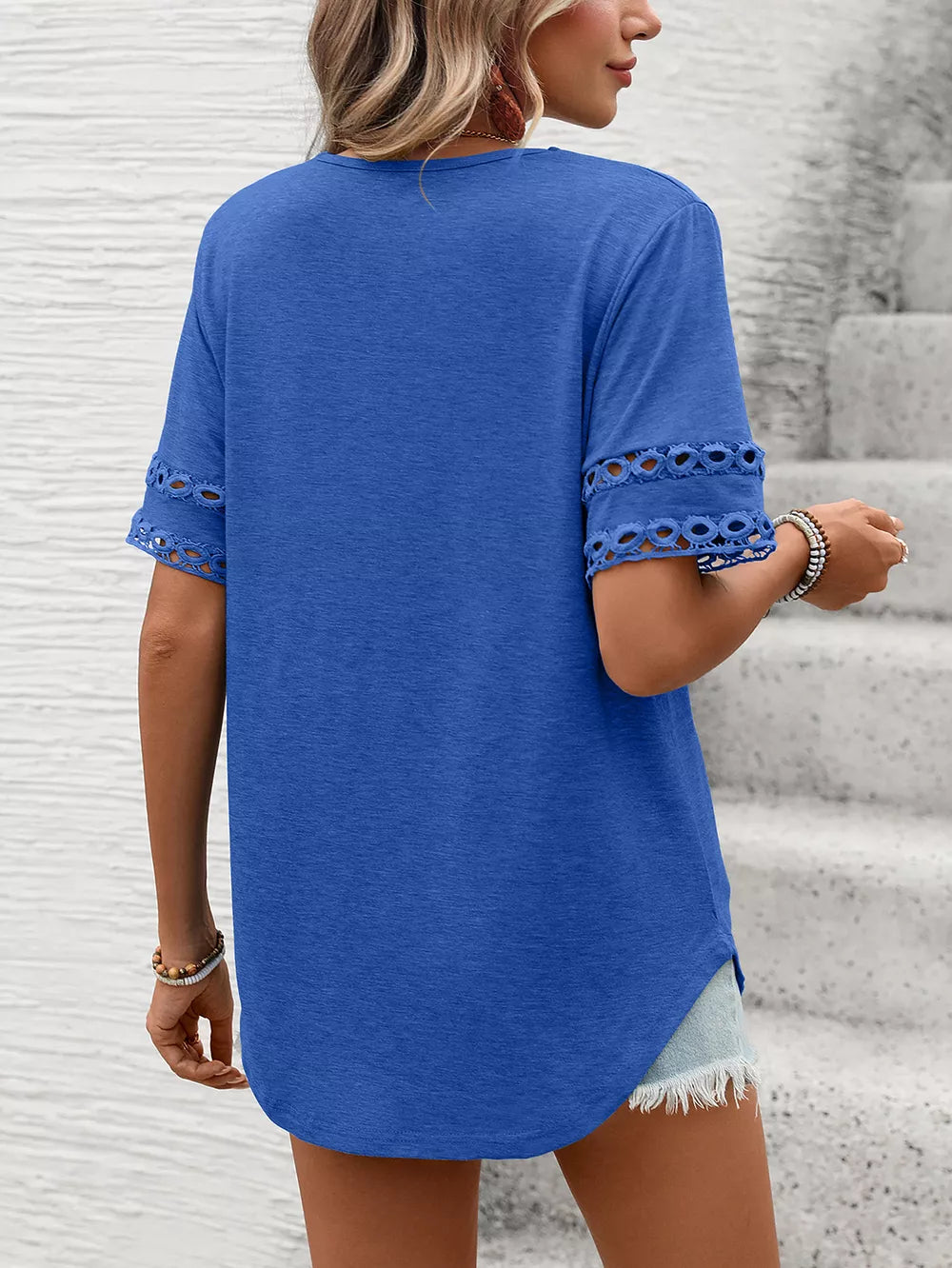 Blue maternity t-shirt with lace trim on the sleeves and V-neck.