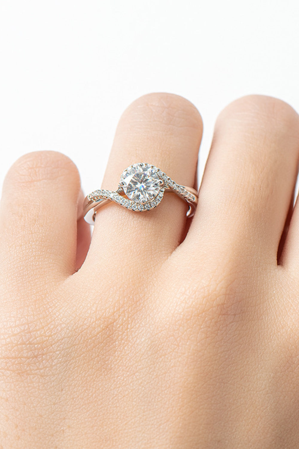 Silver swirl halo moissanite engagement ring with pave band