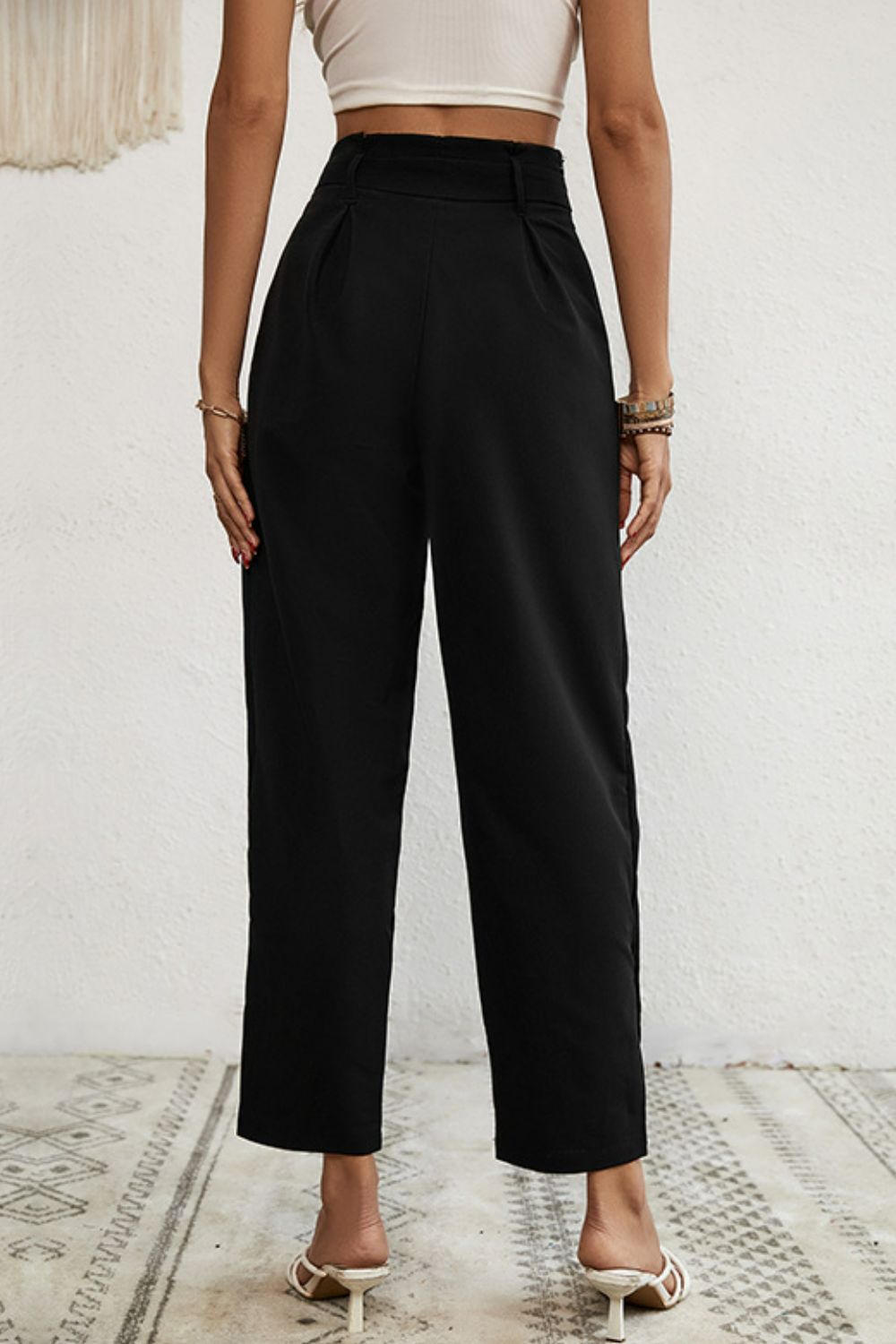 Black paperbag waist trousers with buttoned hem detail