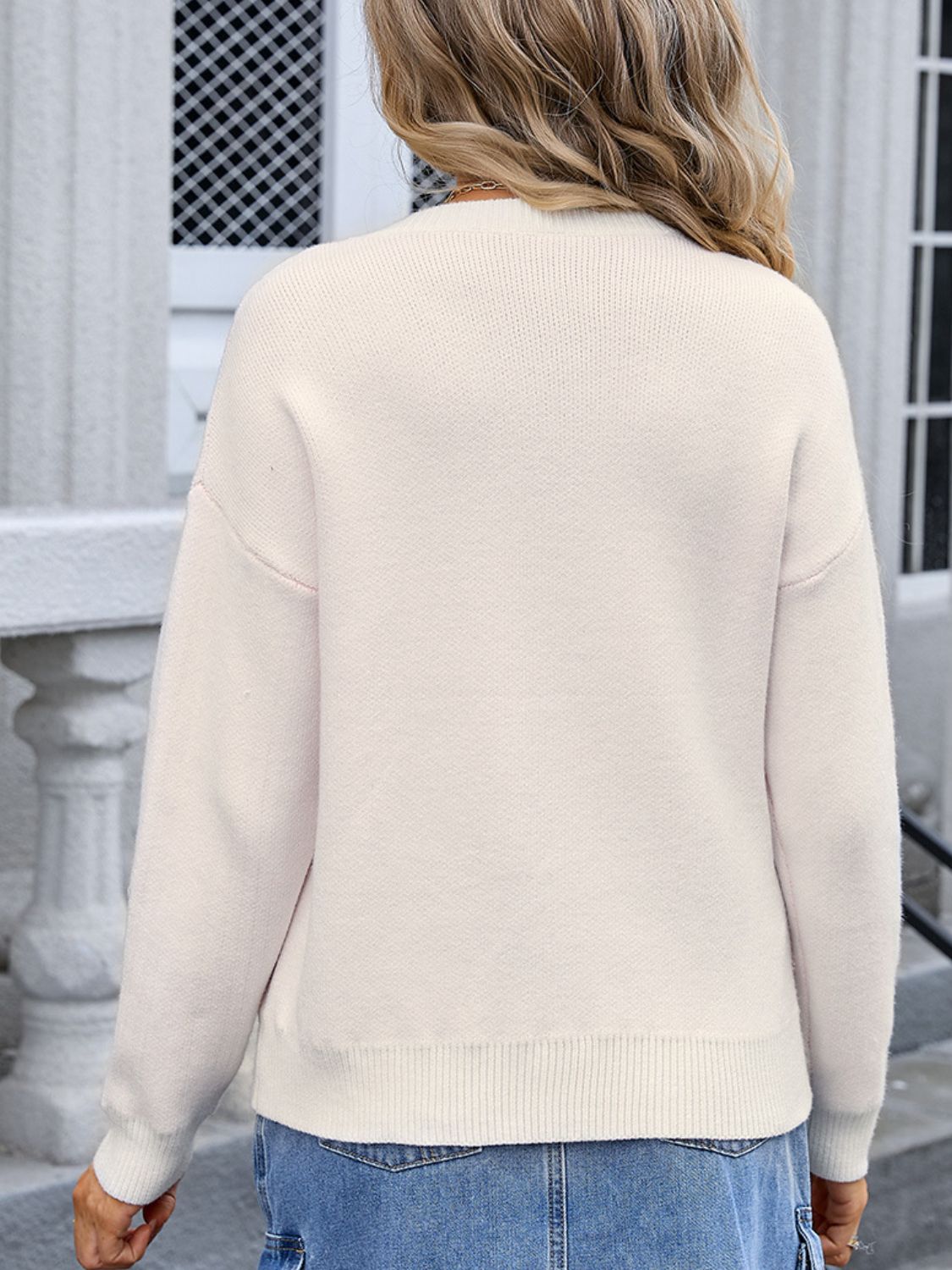 Cream acrylic knit sweater with crew neck and ribbed cuffs and hem.