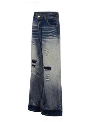Men's distressed blue wide-leg bootcut jeans with ripped details
