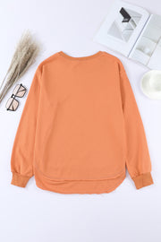 Orange sweatshirt with asymmetric hemline and crew neck