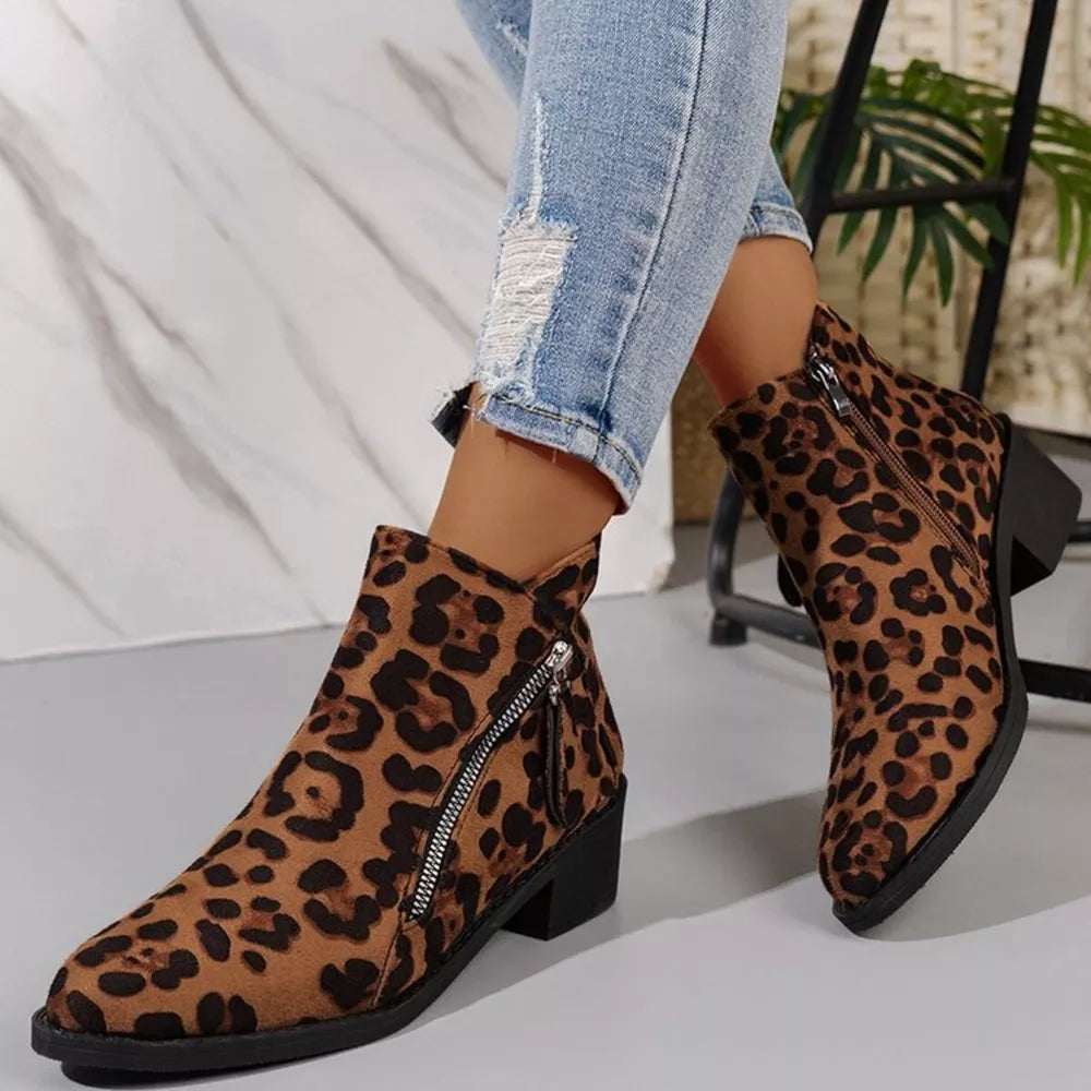 Leopard print suede ankle boots with pointed toe and block heel, featuring a side zipper.