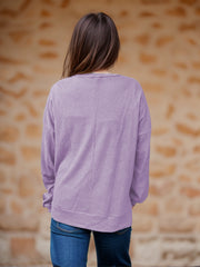 Lavender waffle knit relaxed fit crewneck top with long sleeves.