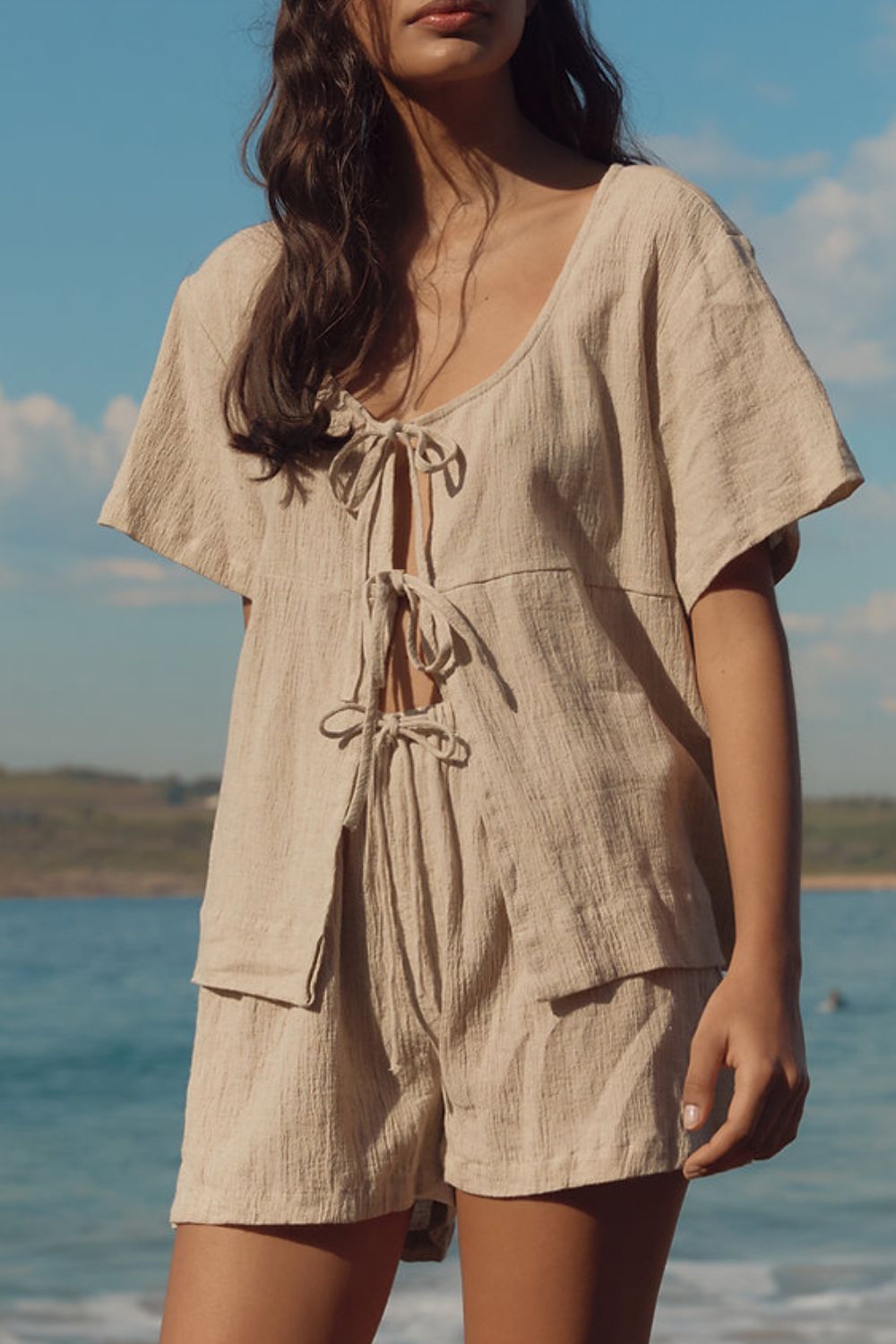 Beige cotton tie-front open top and shorts set with textured fabric.