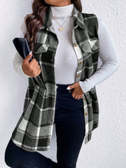 Oversized plaid shirt vest in black and white with button front and chest pockets.