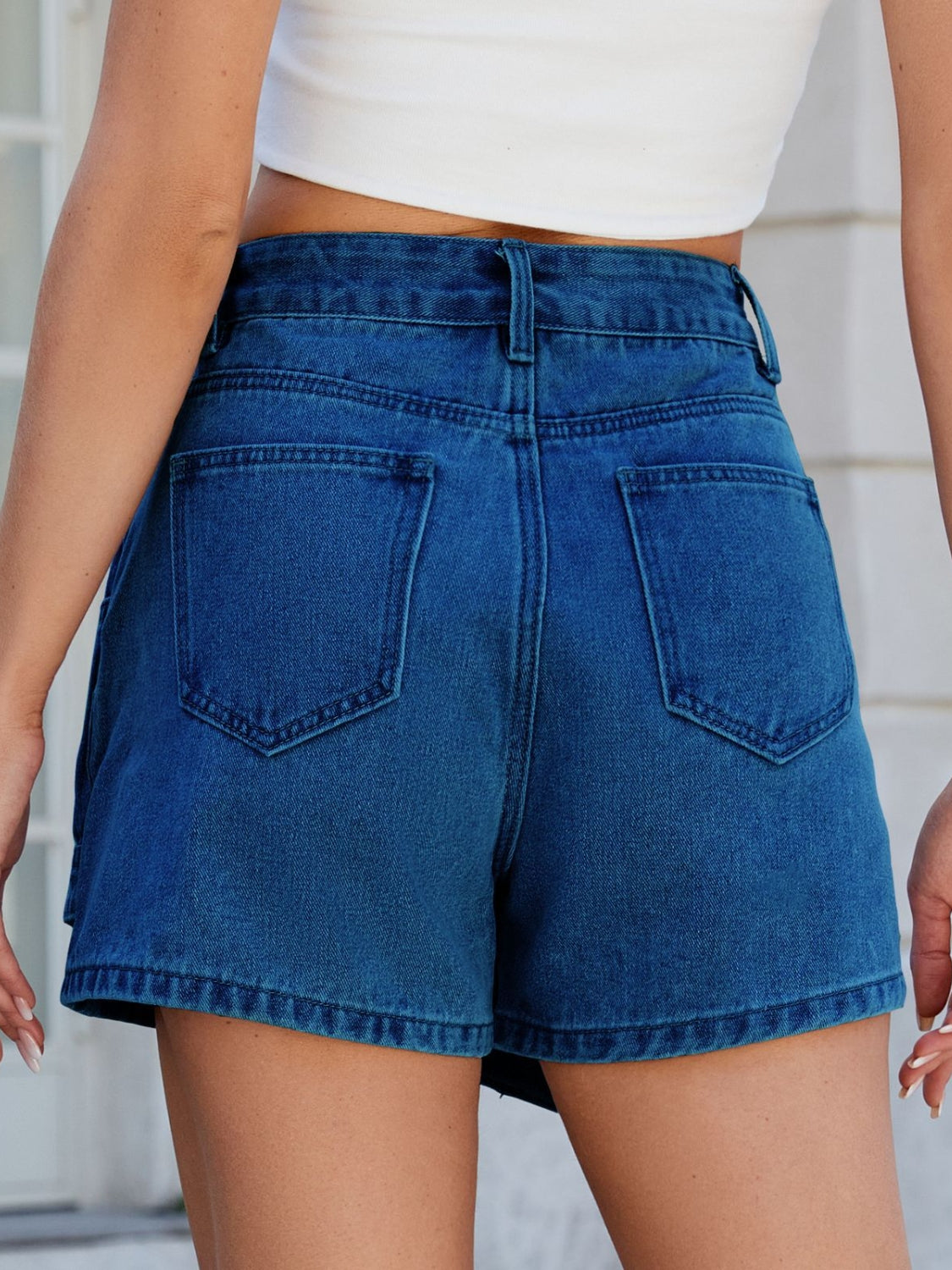 Light blue denim skort with wrap-effect front and angled seams.