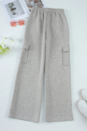 Gray wide-leg cargo lounge trousers with utility pockets and elastic waistband.